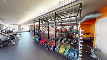 a workout room with weights and other gym equipment